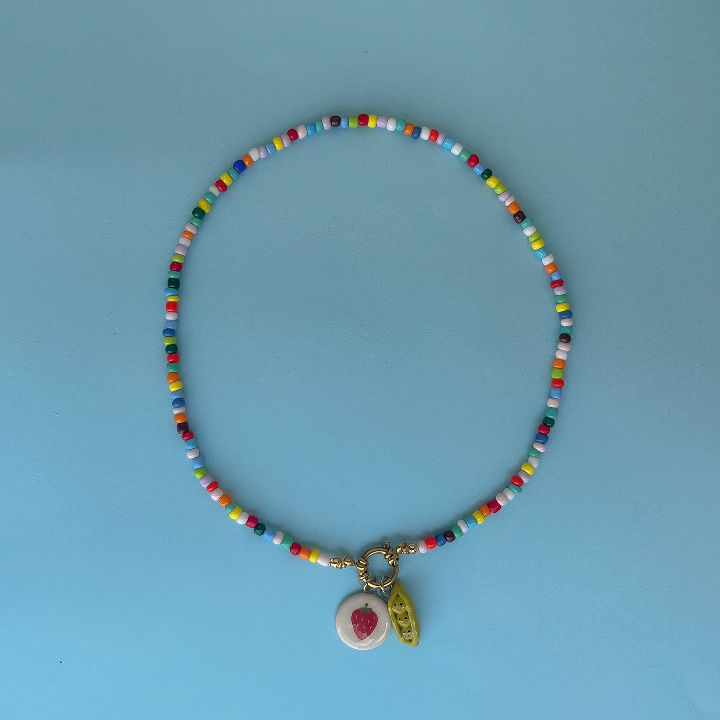 Collana colorata con ciondolo fragola e pisellini